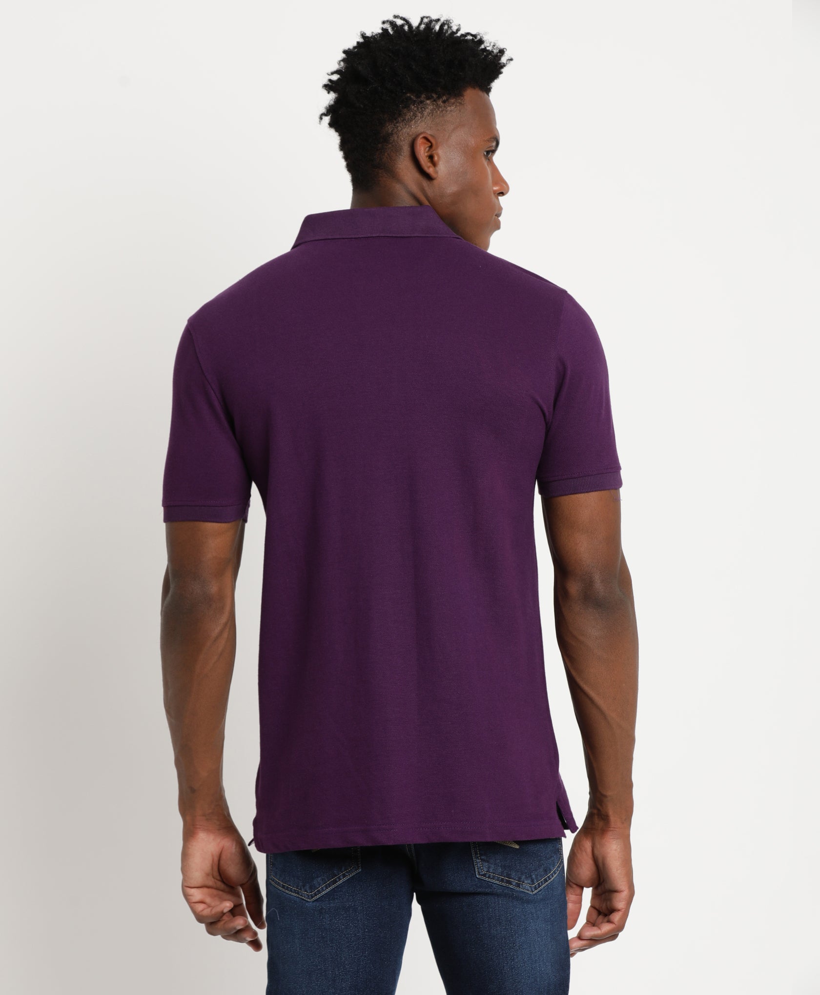 Young Beautiful male model in purple polo T-shirt and dark black